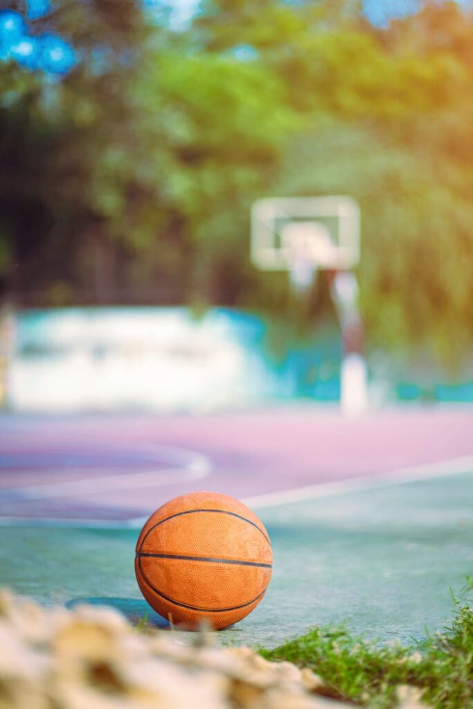 Bright summer day on a New Delhi basketball court with a focus on a single ball.